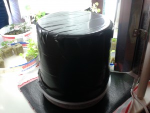 The top of the ice-cream bucket covered with duct tape.